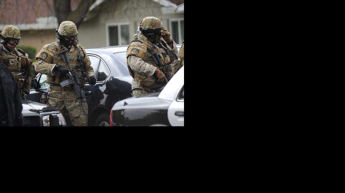 
 Modesto police officers prepare to enter the Chrysler Drive scene on April 12, 2012, in Modesto.
