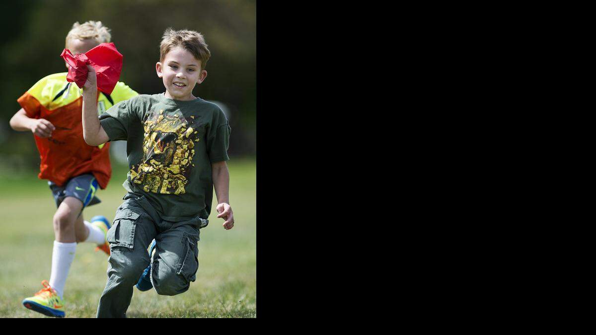 
Mason Pereira, 8, of Turlock is chased during a game of capture the flag at the All-Sports Camp at California State University, Stanislaus, in Turlock on Monday.
