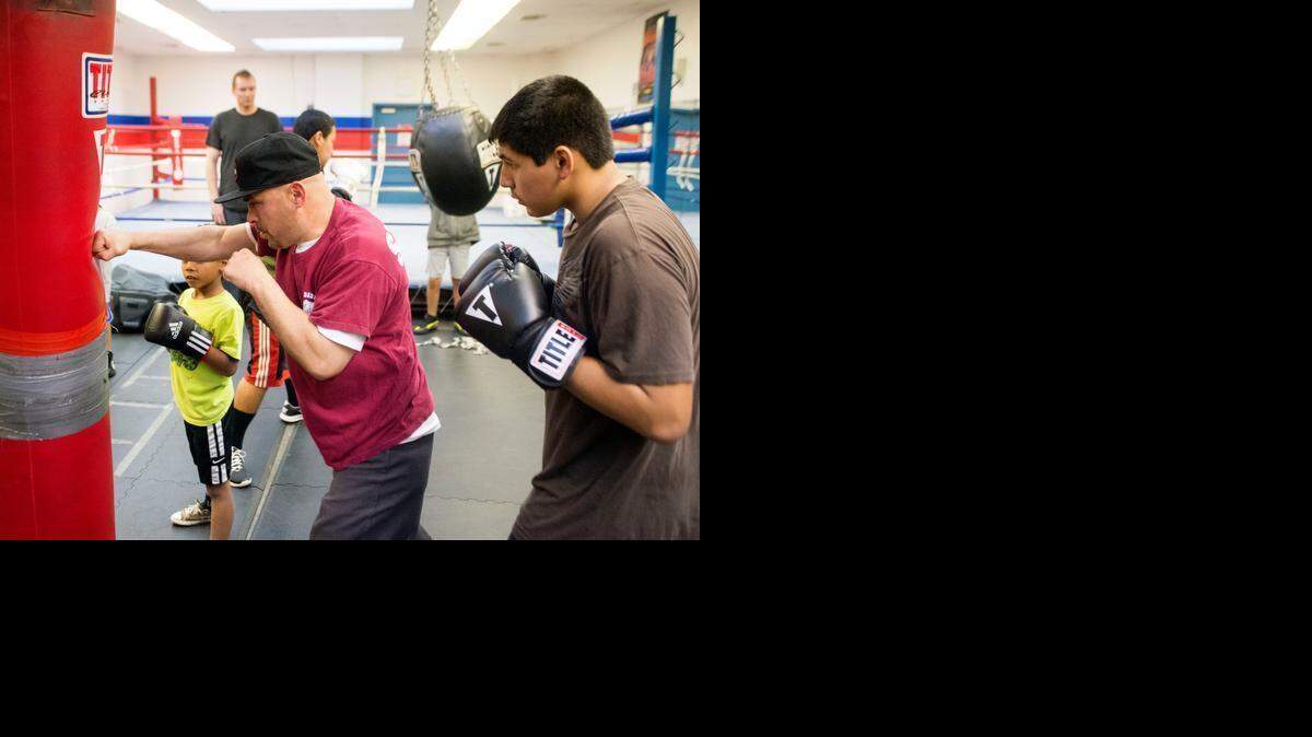
Coach Juan Barrera, center, demonstrates punching a bag for Moises Acevedo, right, on Wednesday, Jan. 28, 2015, during a boxing class offered by the Salvation Army’s Red Shield Center in Modesto. The program is led by Barrera. Classes are offered Monday through Friday from 4:30 to 6:30 p.m. for ages 5 and up. The center has a sanctioned boxing team that competes around California. The program helps build confidence and self-esteem, and offers a safe environment. The Salvation Army Red Shield Center is at 1649 Las Vegas St.
