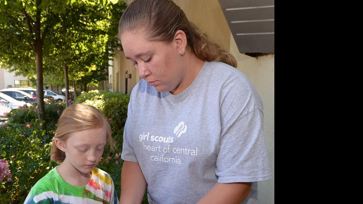 
Girl Scouts counselor in training Alexandra Potts helps Aamie Bertolosso with her tie-dye project on Thursday morning during day camp in Salida.
