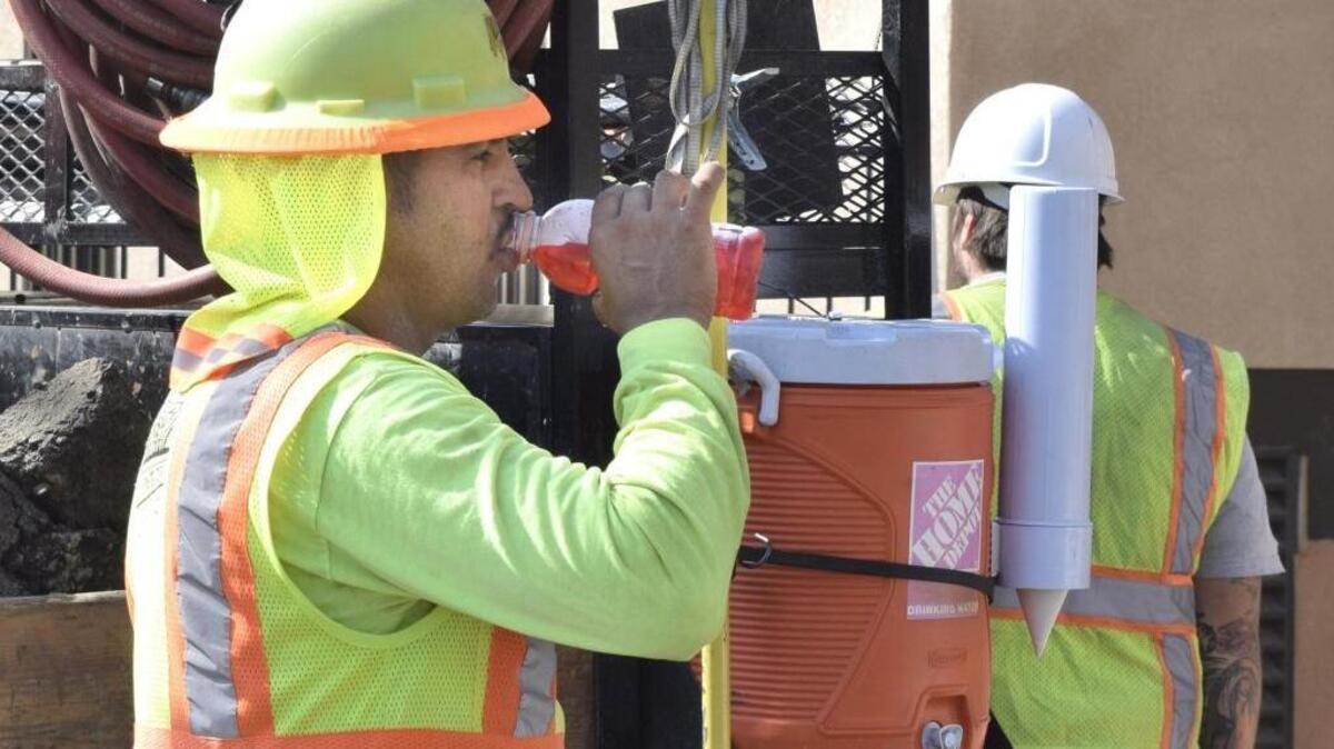 Construction workers doing in-ground pipe work outside the Medical Arts Building at 700 17th St. in downtown Modesto on Monday morning (07-25-16) were ready for the heat, with water jugs and cups on the backs of their trucks. Daniel Gutierrez with Irish Construction of Ceres re-hydrates with a sports drink about 9:45 a.m. Monday.