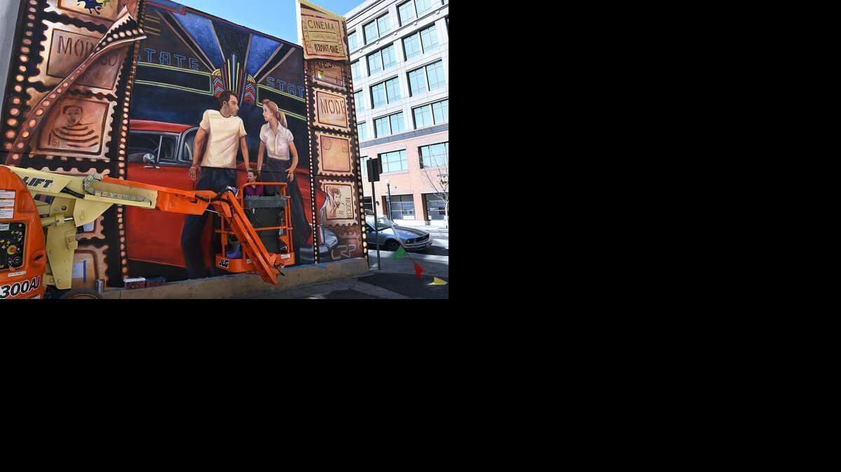 
Artist Ella Yates uses a bucket lift to complete work on a mural Tuesday in an alley off the 1000 block of J Street in downtown Modesto. This is the 10th mural to be completed in the Classic Community Murals project. Work by artists Yates and James Devlin started four days ago and finished up Tuesday.
