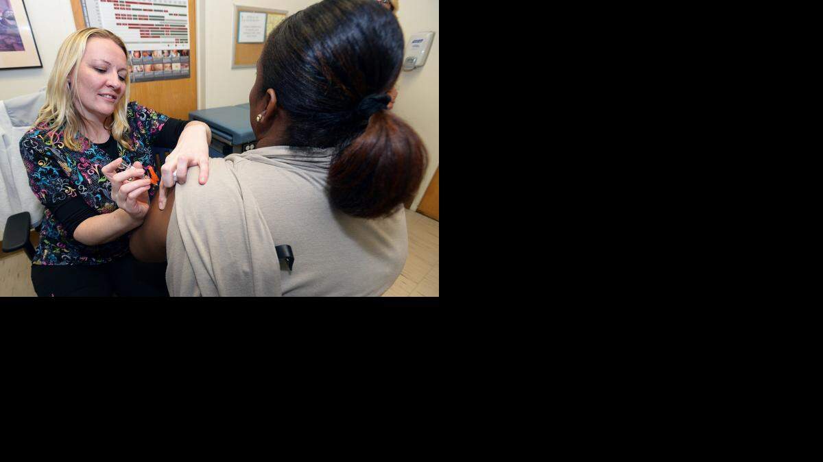 
Registered nurse Dee Arata administers the flu vaccine to Adrienne Tompkins on Tuesday at the Stanislaus County Health Services Agency on Scenic Drive, Jan. 6, 2015.
