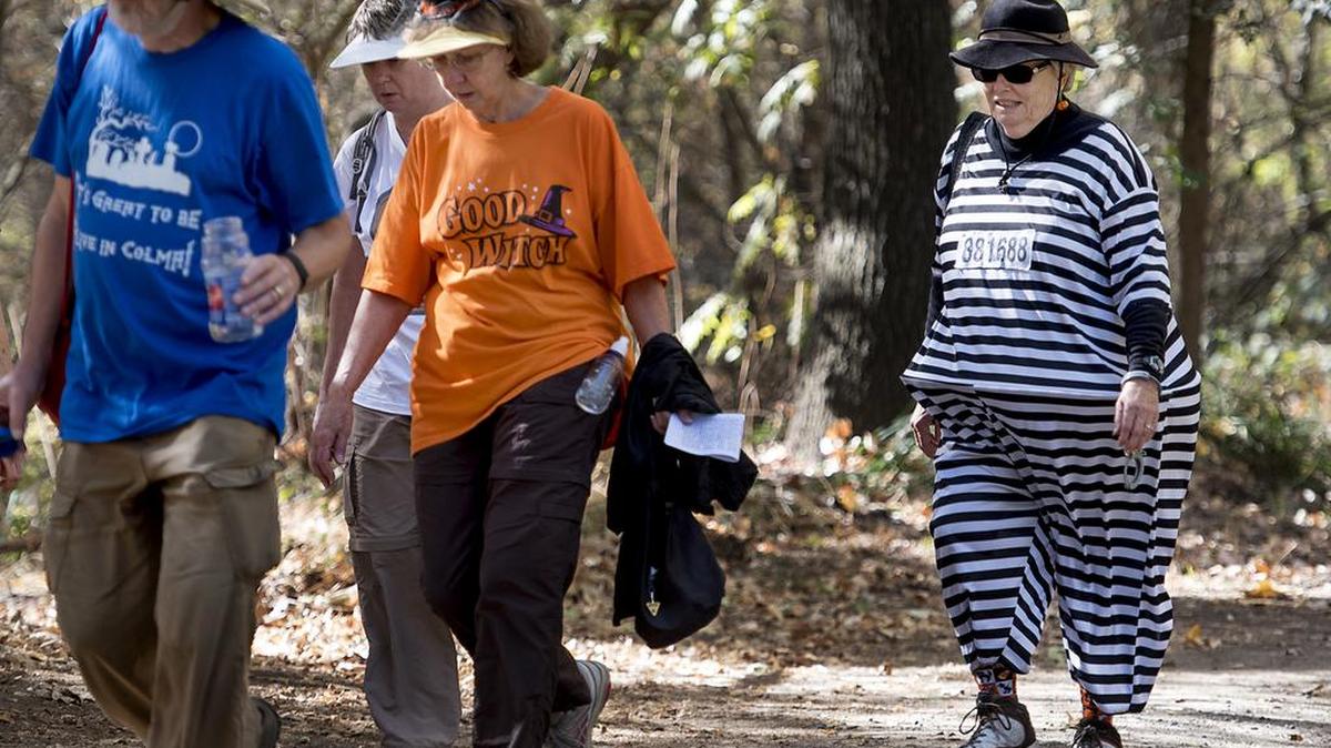 Marilyn Ratliff of Newcastle, dressed as a prisoner, and Judy Gordon of Reno, in orange, walk with friends during the 5K Spook Walk at Caswell State Park in Ripon on Saturday, Oct. 31, 2015.