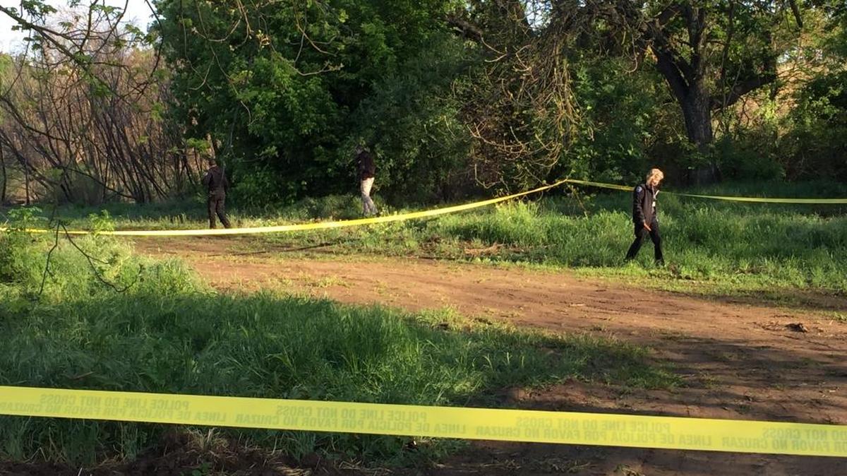 Modesto police personnel work the scene at Legion Park where a man was found dead from knife wounds in his vehicle Sunday night.