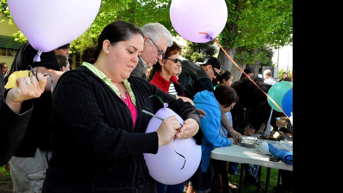 
Carrie Pontes fills out a wish note for her sister, domestic violence victim Christine Tallent, before the balloon release on Saturday at the Victims’ Rights Rally and Family Safety Fair at the Stanislaus County Courthouse in Modesto.
