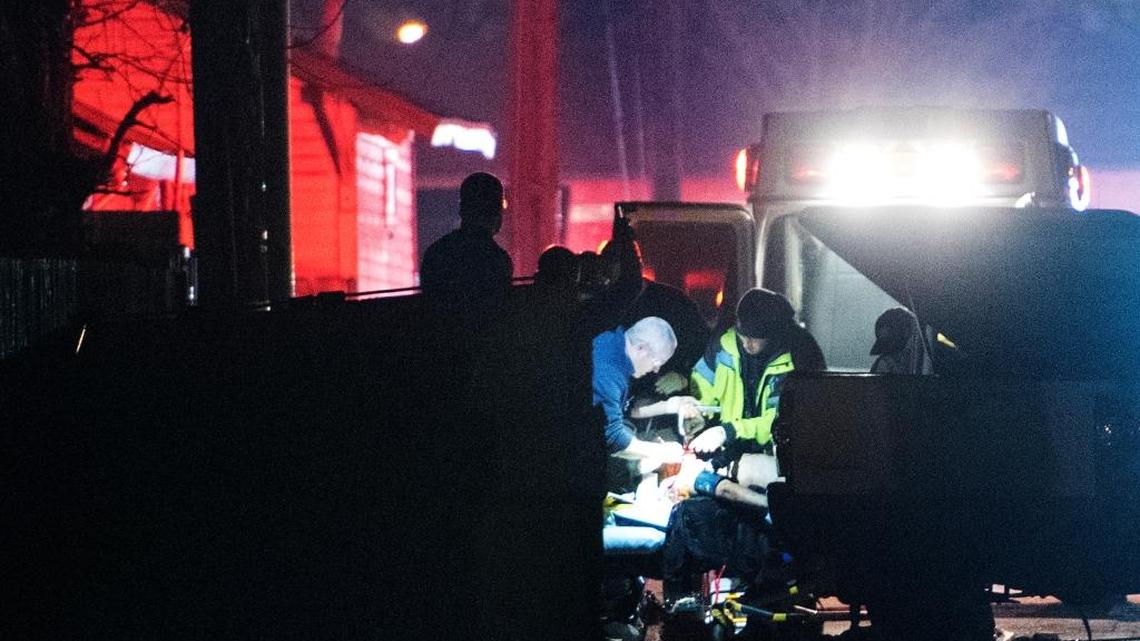 Paramedics render aid to Derek Mauldin, who was shot in an alley near 15th Street in downtown Modesto, California on Tuesday Jan. 12, 2016.