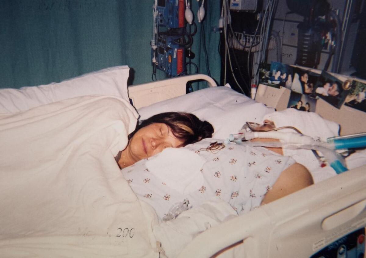 Julie Sandoval-Preciado with her son Erik Sandoval Preciado in the hospital after he was shot.