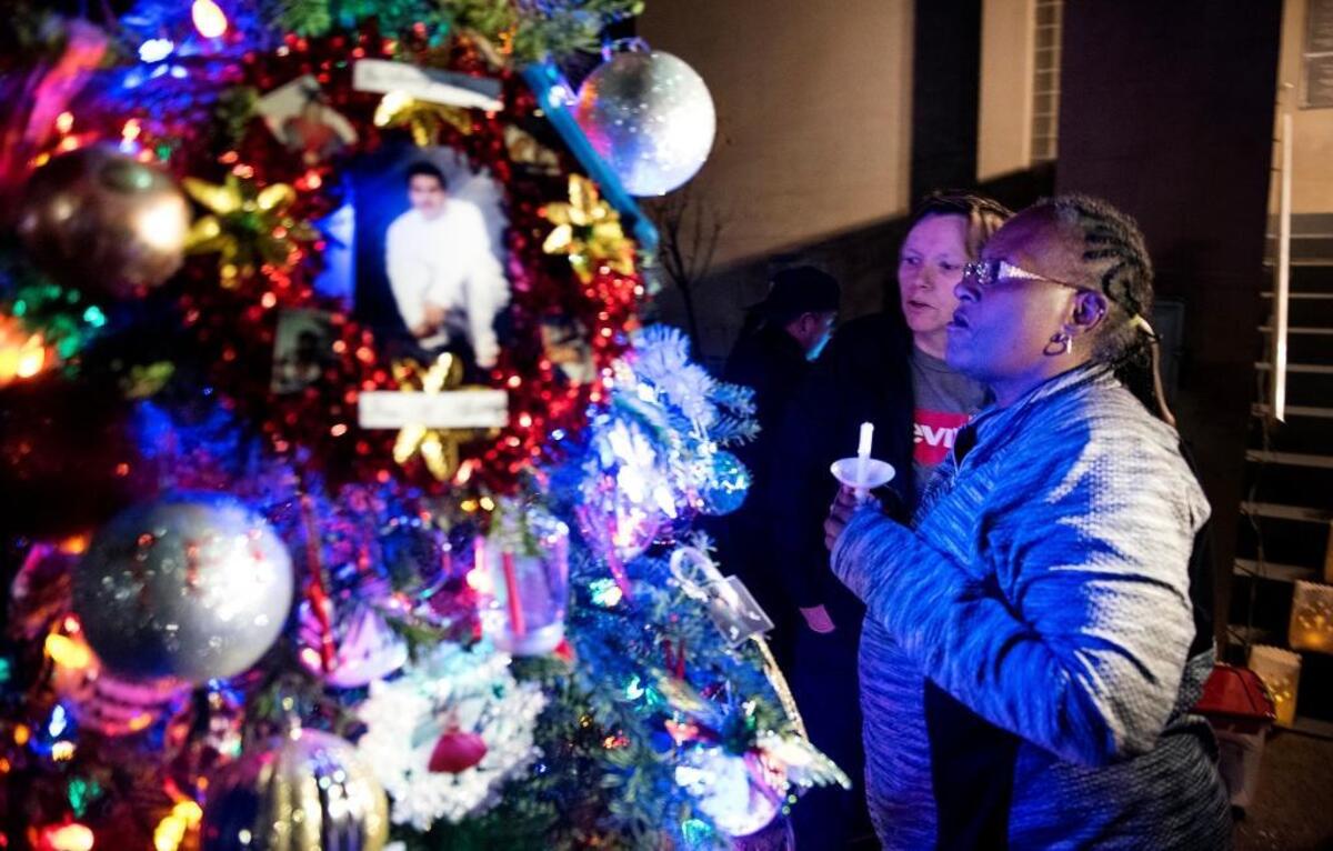 Maisy Avila, mother of Edward Reinig, looks at the memorial tree during the Lighting of the Homicide Victims’ Memorial Tree and Candlelight vigil at the Stanislaus County Courthouse in Modesto, Calif., on Thursday, Dec. 7, 2017.