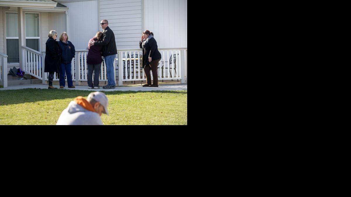 
Family and friends pause outside the Mingham home Friday, a day after Steve Mingham fatally shot his wife and children and then himself, according to authorities.

