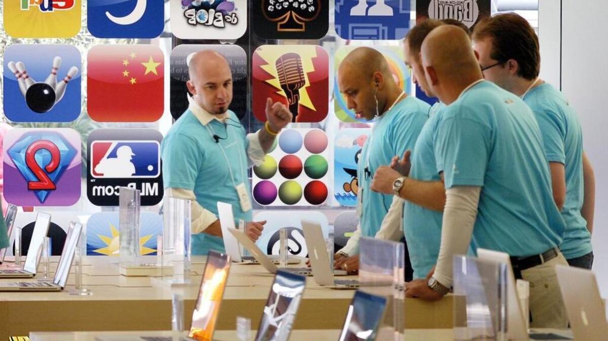 In this November 2008 file photo, Apple Store employees prepare for the store opening at The Village in the Vintage Faire Mall.