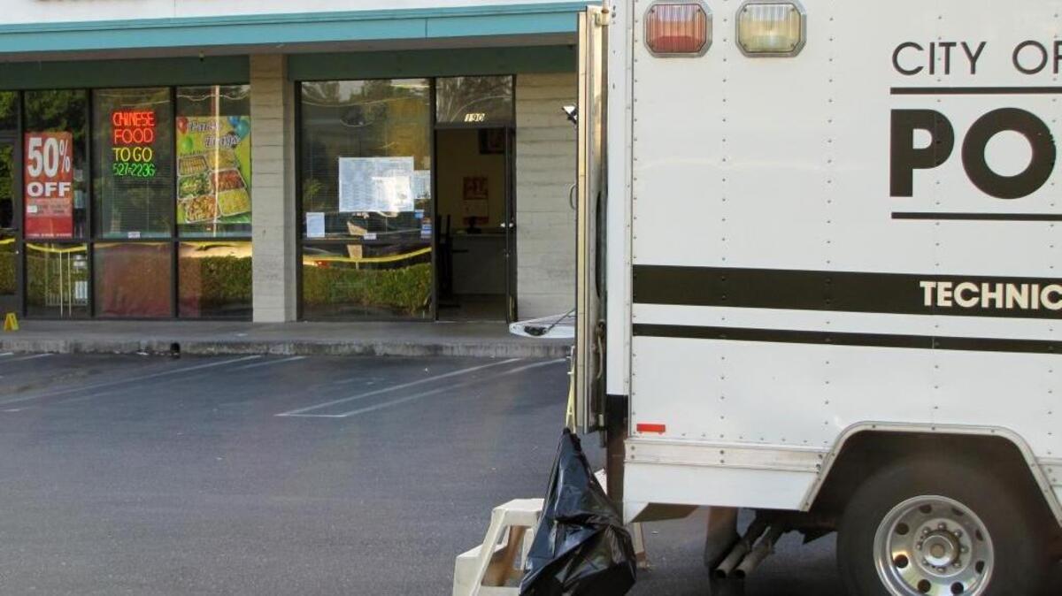 (Brian Clark/bclark@modbee.com) - The door to China Gourmet restaurant in Modesto's Center Center shopping plaza remained open hours after the body of an assault victim was discovered inside the business on Oakdale Road in Modesto, CA., on Thursday, May 5, 2011.