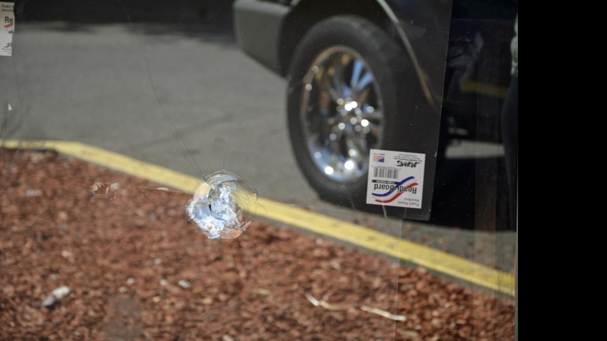
A bullet hole is seen in the glass door of Simply Unique Hair Boutique at 3800 McHenry Ave. in Modesto. A woman suffered non-life-threatening wounds after being shot on Friday.
