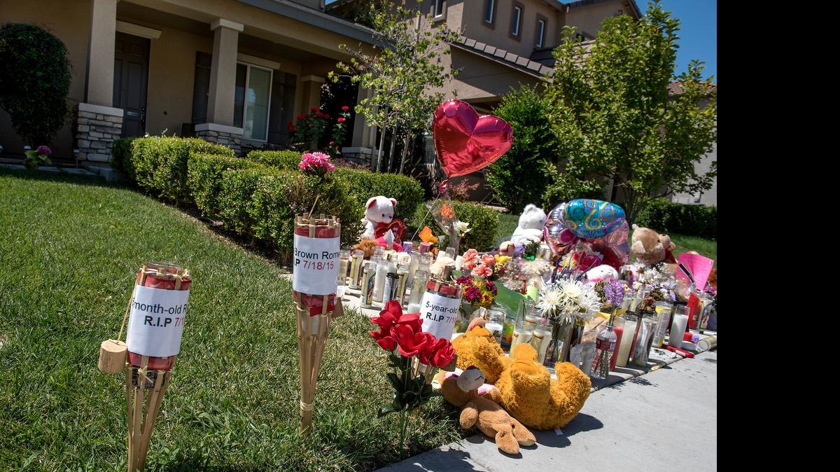 
A memorial is held for victims of a homicide on Nob Hill Court in Modesto on Thursday.
