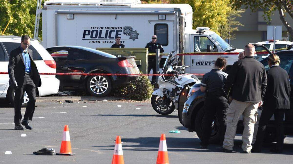 Detective Sean Dodge (left) and other law enforcement work the scene Nov. 6, 2017, where Modesto police Sgt. Jerry Ramar, show Jason Perkins on Oakdale Road near Lancey Drive.