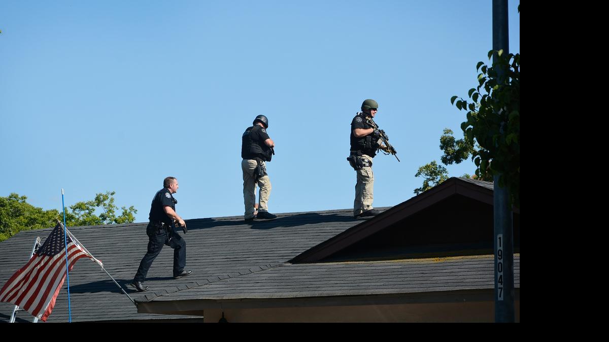 
Modesto Police on Monday afternoon search the roof of a home on Dry Creek Drive (Erin Tracy/etracy@modbee.com).
