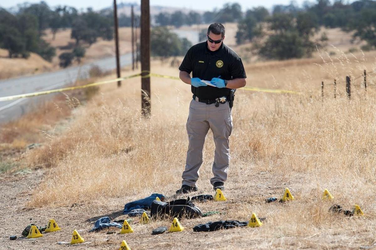 Stanislaus County sheriff’s detective Joshua Sandoval investigates a homicide on La Grange Road near Cooperstown Road, near La Grange, on Wednesday, Oct. 7, 2015.