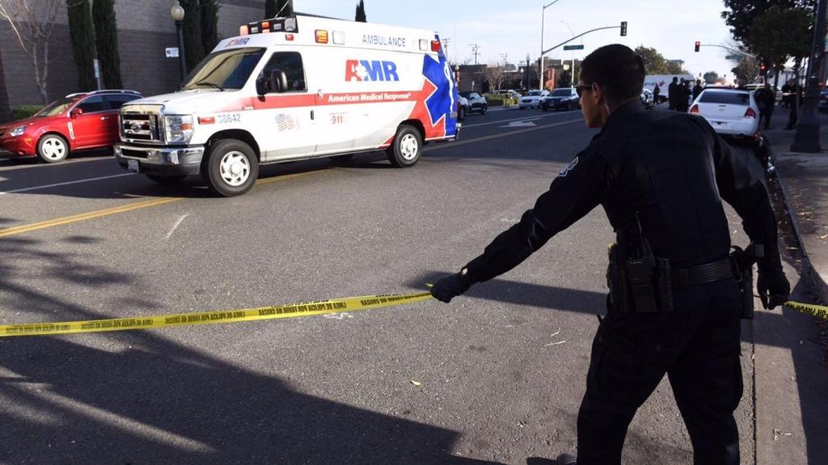 A Modesto police officer works the scene of an officer involved shooting on 10th street in downtown Modesto, Calif. on Thursday (12-17-15).