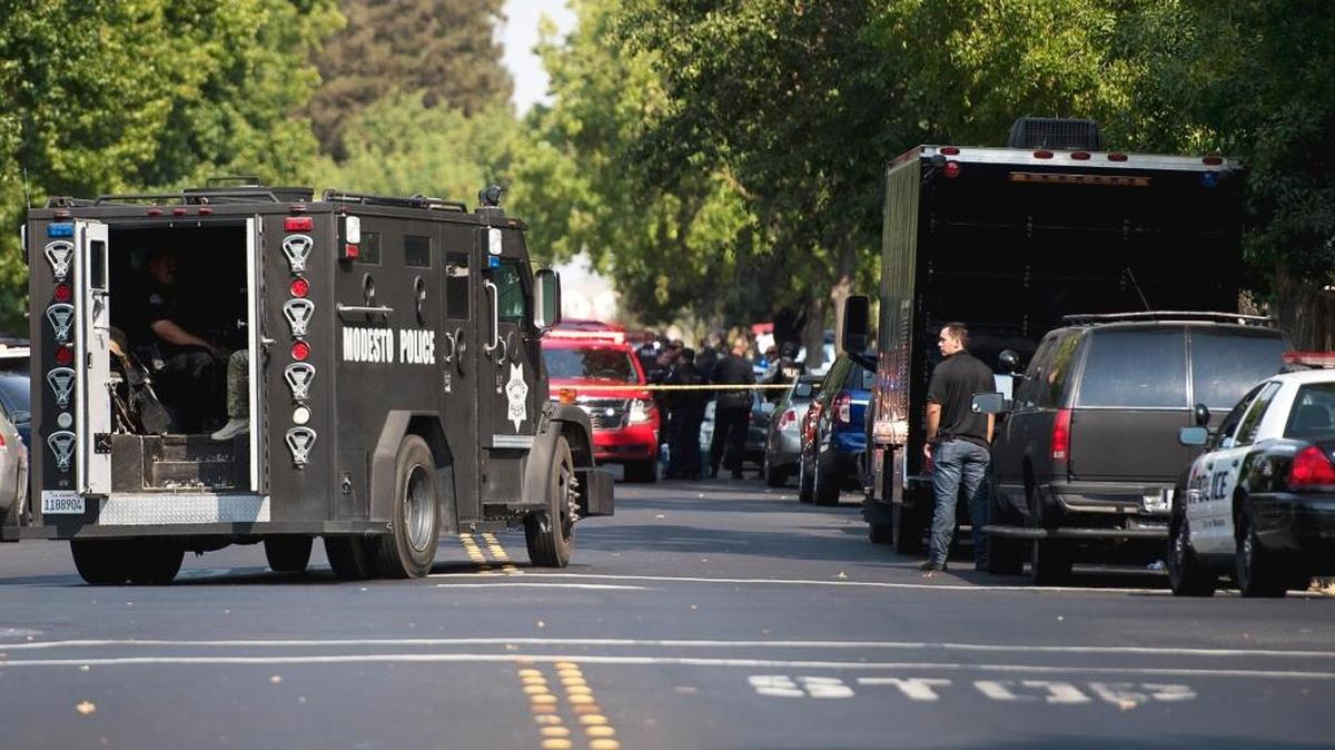 Modesto police work at the scene on East Rumble Road near Keller Street in Modesto, Calif., on Thursday, Aug. 18, 2016, where reports of shots fired triggered a search for those involved.