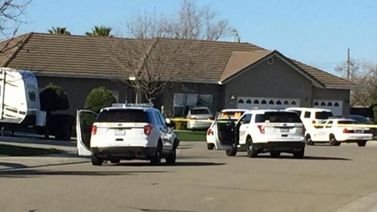 The scene Sunday morning, Feb. 26, 2017, in Ripon, Calif., following an officer-involved shooting involving a Stanislaus County Sheriff's Department deputy. Outside a home on Tornell Court were law enforcement vehicles and the suspect vehicle that is against the house.