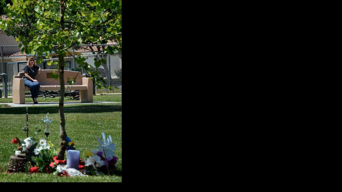 
In this file photo from May 2013, Violet Crippen-Hachey pauses for a moment on a memorial park bench at the site where her son Tylor Crippen was the victim of an attempted robbery Jan. 29, 2013, after he and his girlfriend decided to end their evening together with a walk through Creekwood Park.
