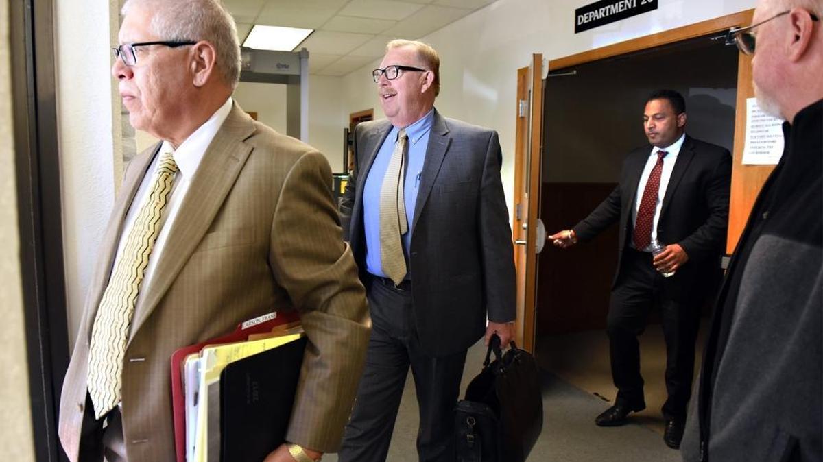 Prominent defense attorney Frank Carson (center) leaves court with his attorney Percy Martinez (left) in April. Also pictured is co-defendant Baljit Athwal (in doorway).