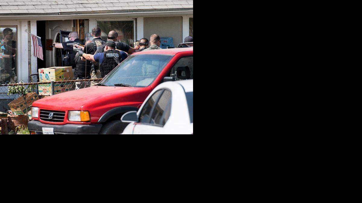 
Sheriff’s deputies and probation officers search a home on South Seventh Street in Modesto on Tuesday.
