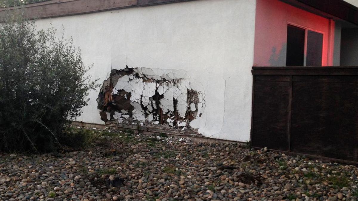 A man crashed into a house in southwest Modesto on Tuesday evening, March 15, 2016, while chasing men suspected of robbing his son.