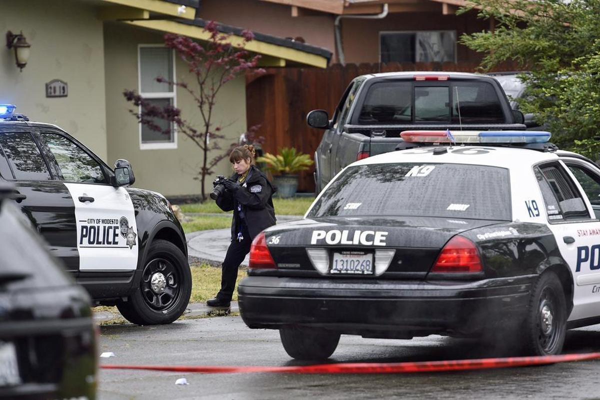 Modesto Police Department personnel work the scene on Lance Street after a suspect was shot dead by officers on Sunday, April 10, 2016.