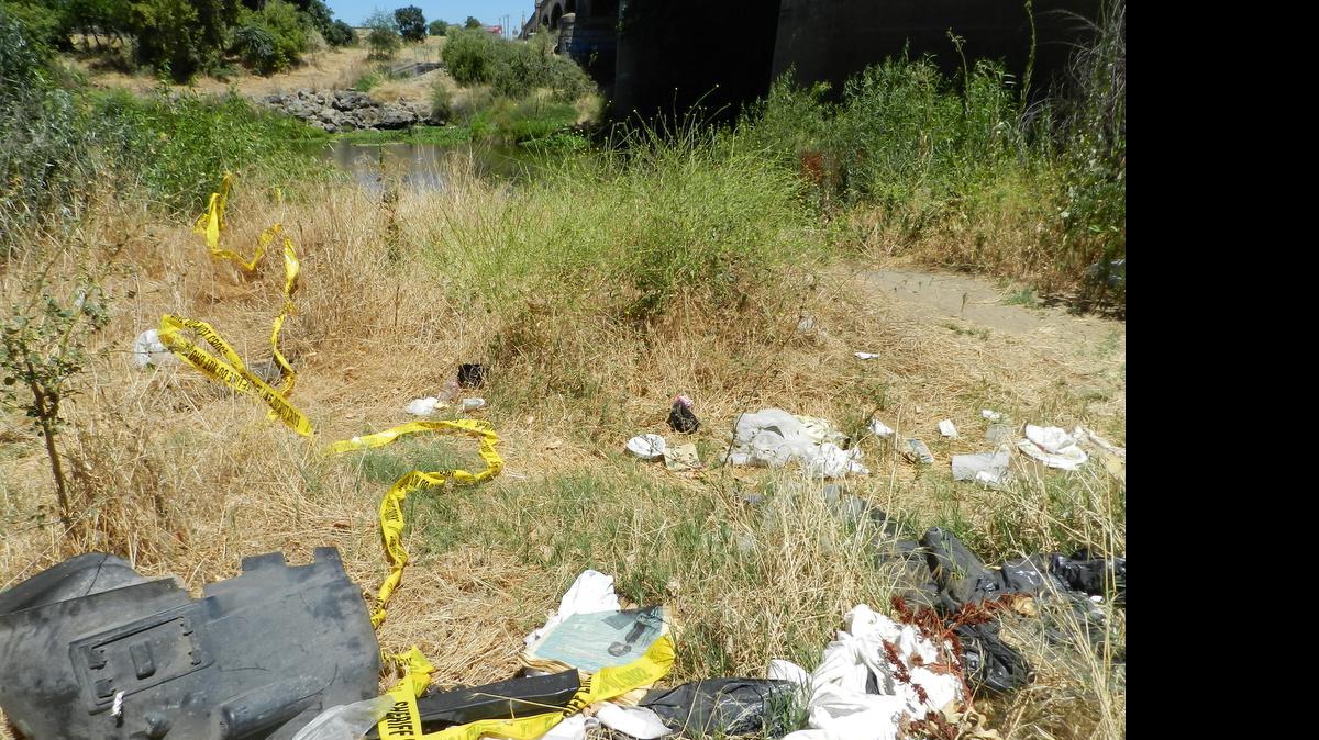 
On Monday, police tape remained at the scene of a homicide investigation along the Tuolumne River at the Seventh Street bridge in Modesto.
