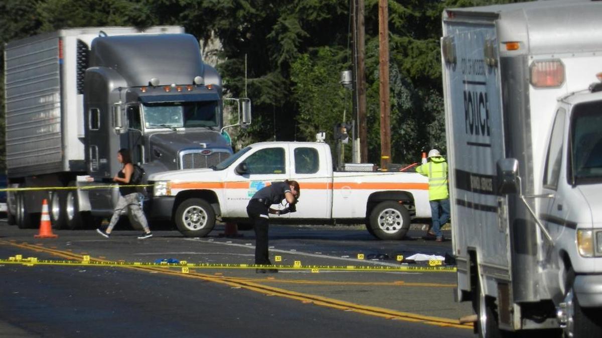 
Evidence at the scene of a fatal accident – a bicyclist was struck by multiple vehicles – is photographed at Carpenter Road and Maze Boulevard on Monday morning. 
