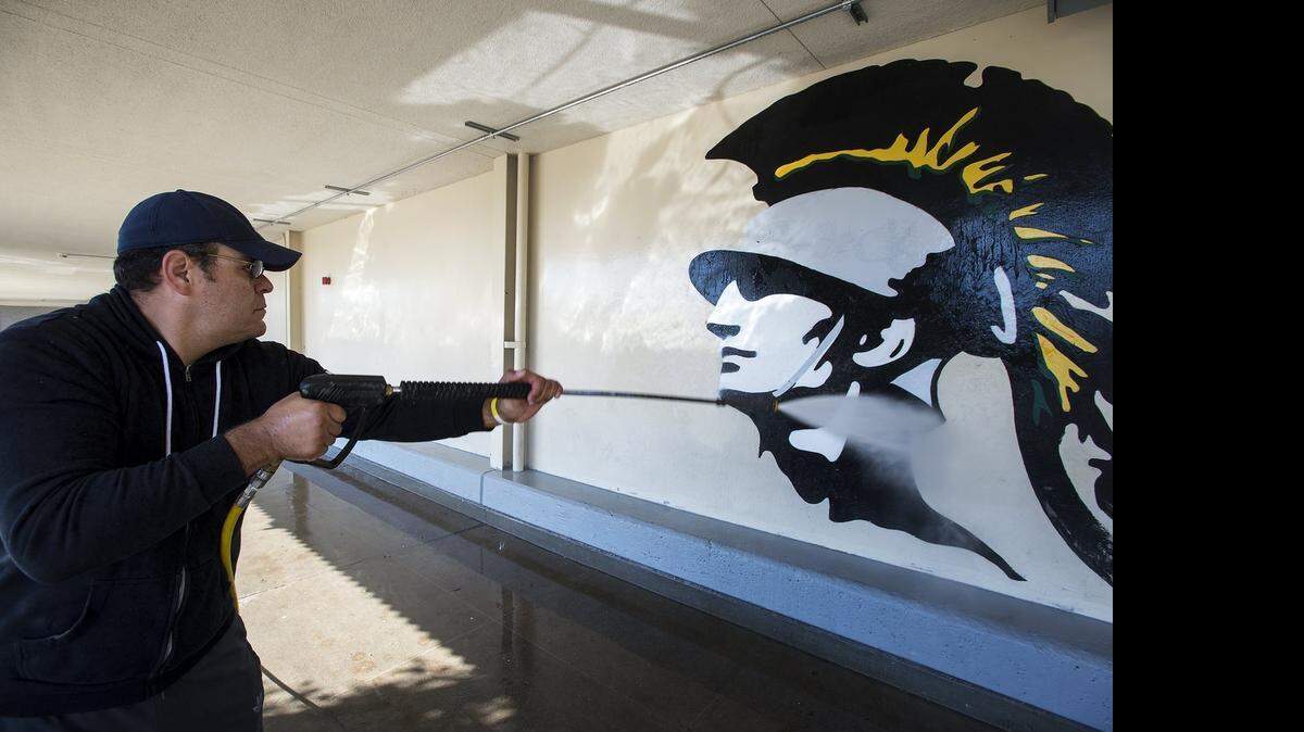 
Sergio Magana cleans a wall at Davis High School with a  pressure washer during last year’s Love Modesto.
