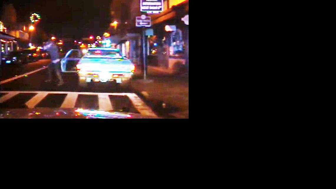 
A still from a patrol car dashboard-mounted video camera shows Bruce Thomas Snyder getting out of his vehicle and beginning to fire with a handgun.
