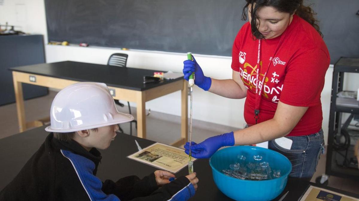 Aspen Padron extracts DNA for Connor Mayben, 10, during Science Day at Stanislaus State in Turlock on Saturday, Feb. 13, 2016.