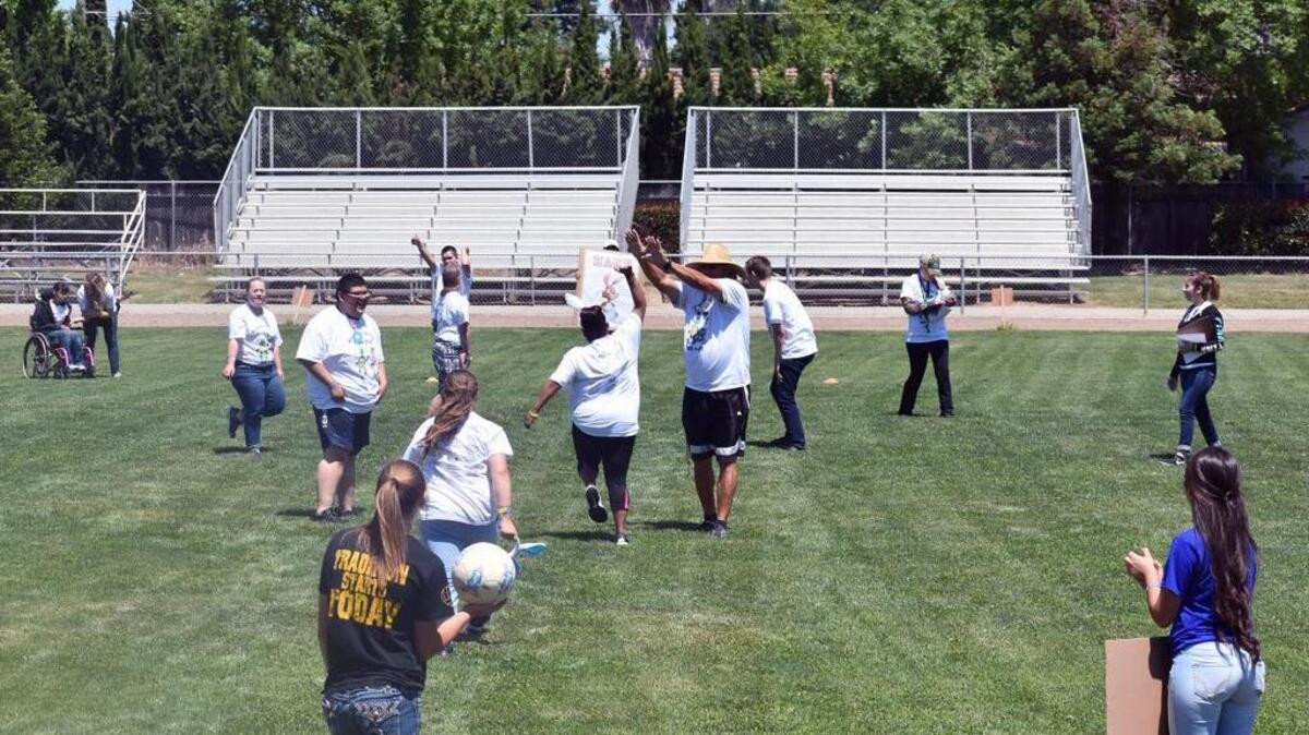 Students and teacher cheer a goal during Field Day at Waterford high school, with leadership students helping out special education athletes and the whole school cheering them on in Waterford, Calif., on (05-12-17).