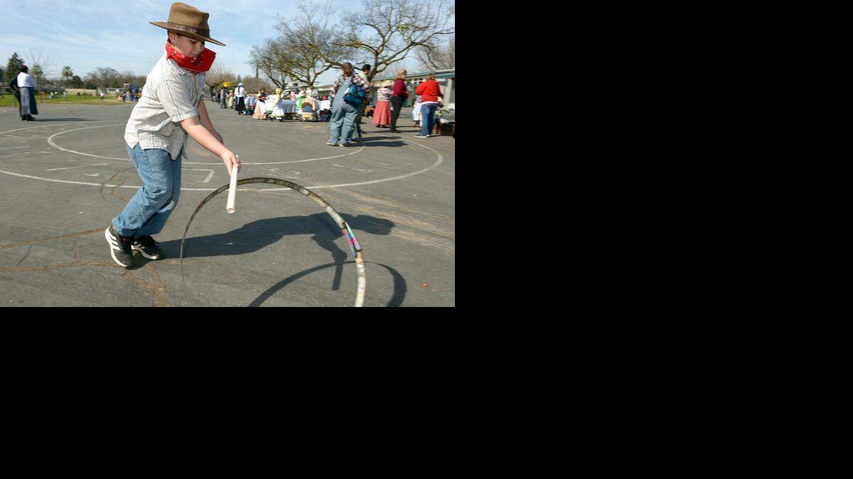 
Tyler Bettencourt, 9, plays with a metal hoop on the blacktop during Pioneer Day in February at Fremont Elementary School in Modesto. 
