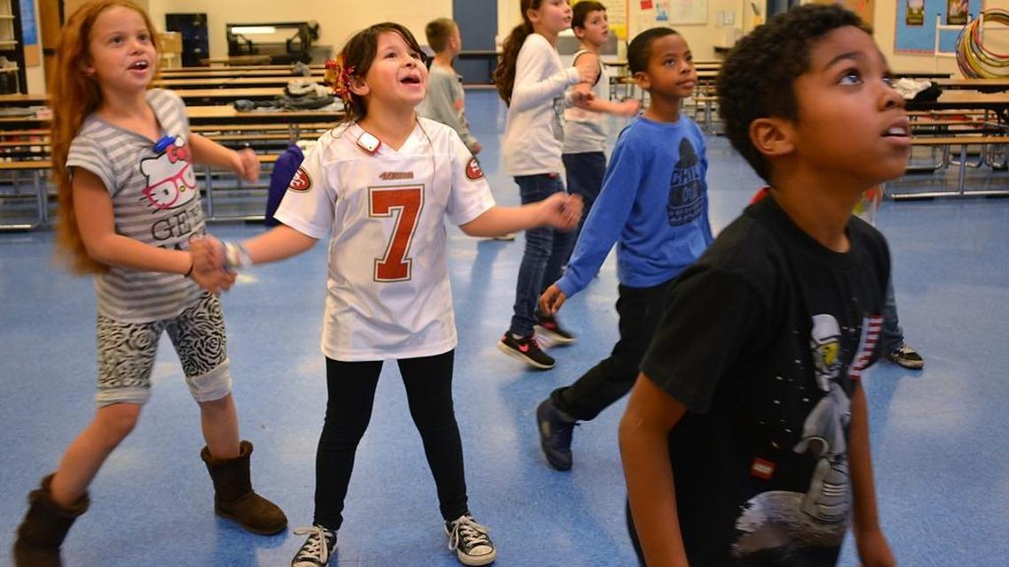Kids move with a rainy-day video exercise program that registers on their pedometers as part of Walk Across America lessons during after-school activities in the Stanislaus Union School District Thrive program at Eisenhut Elementary in north Modesto on Thursday, Dec. 3, 2015.