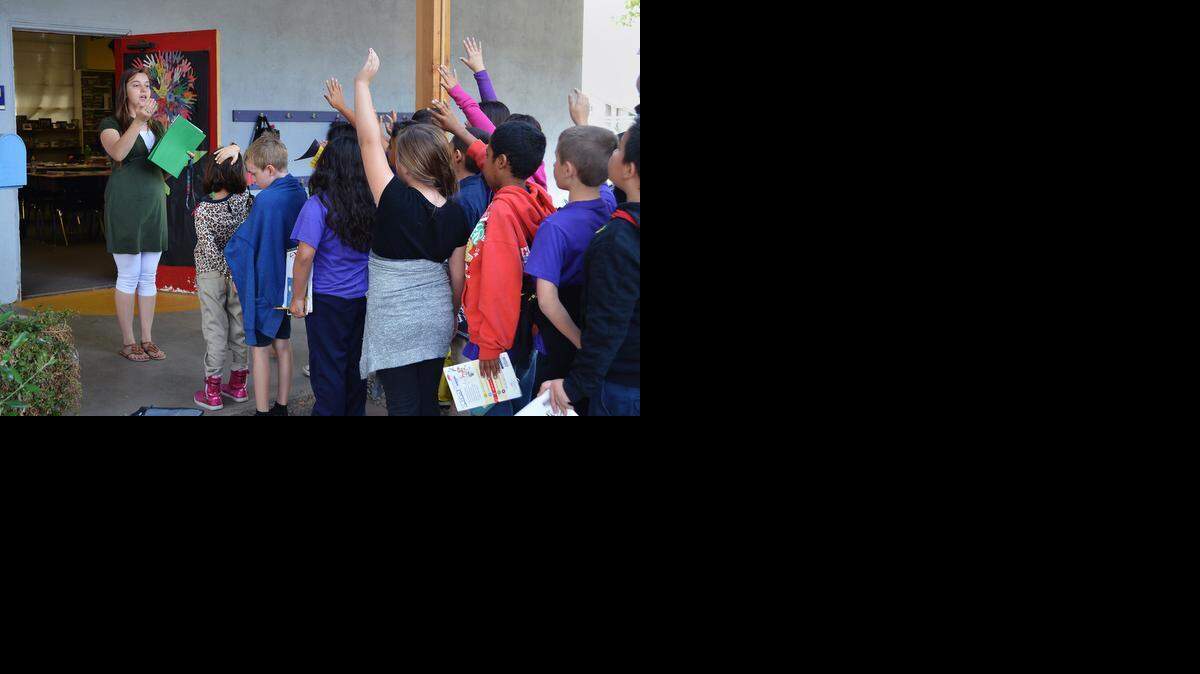 
Fourth-grade teacher Amanda Brown signals for silence before walking her students into the classroom at Aspire Summit Charter Academy in south Modesto.
