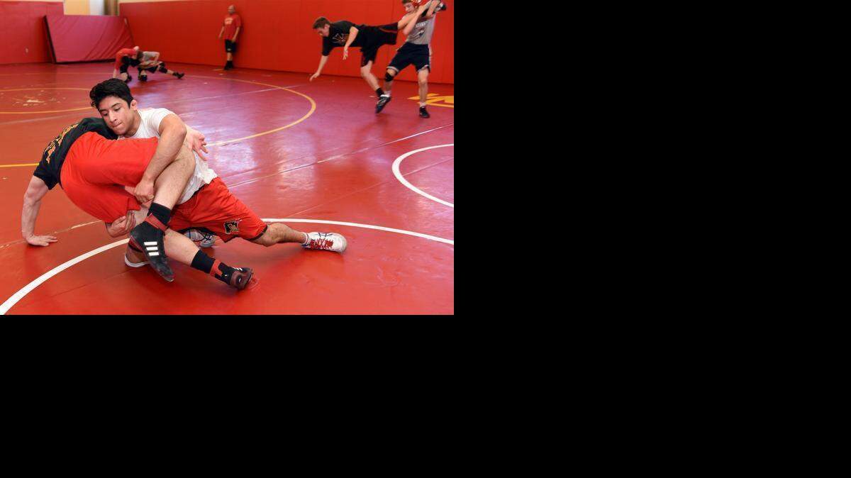 
Abel Garcia, right, wrestles with Frank Trent Wednesday afternoon  during practice at Oakdale High School. Seven students on the school’s wrestling team qualified this year for the state championships.
