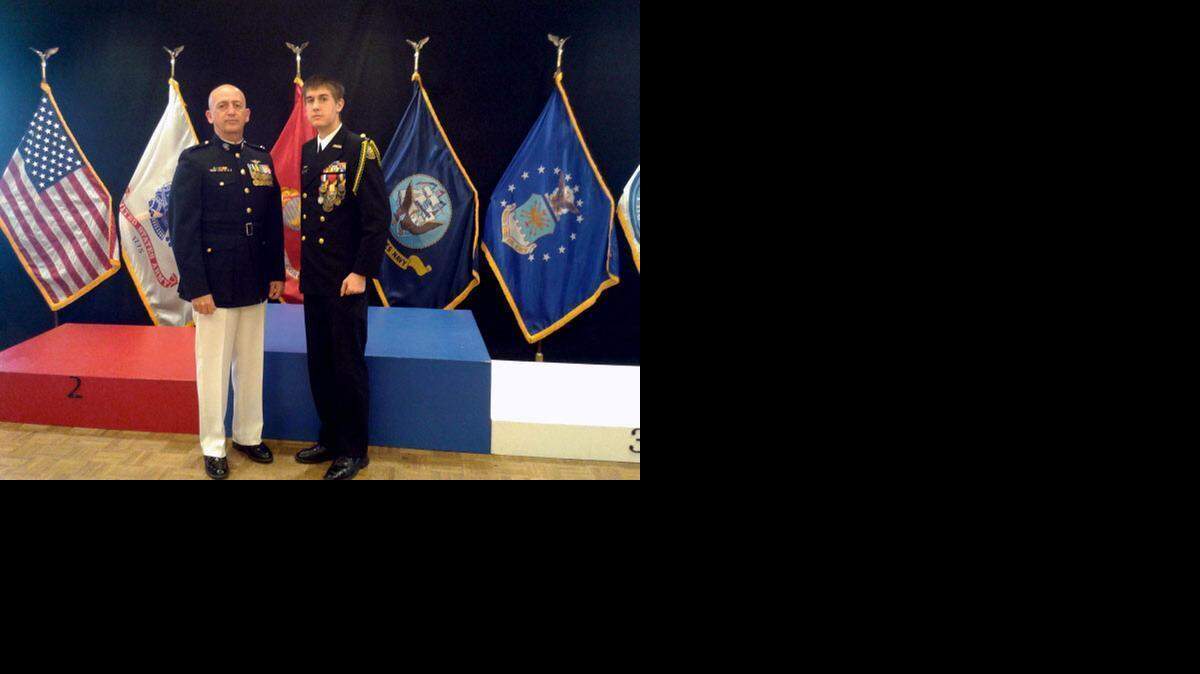 
Turlock High School Navy ROTC instructor Kelly Cross, left, stands with Turlock sophomore Nicolas McKeon at the awards platform of the 2015 JROTC Three-Position Air Rifle National Championship on Saturday at Camp Perry, Port Clinton, Ohio.
