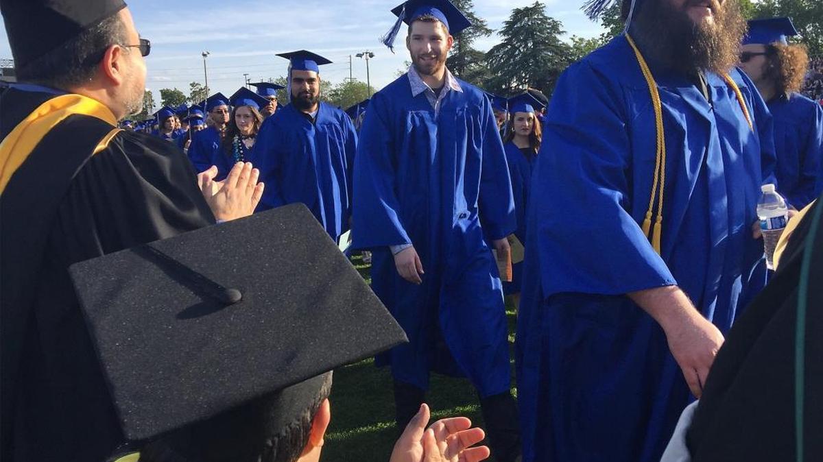 Faculty applaud Modesto Junior College grads as they file in for the commencement ceremony April 29, 2016, in Modesto, Calif.