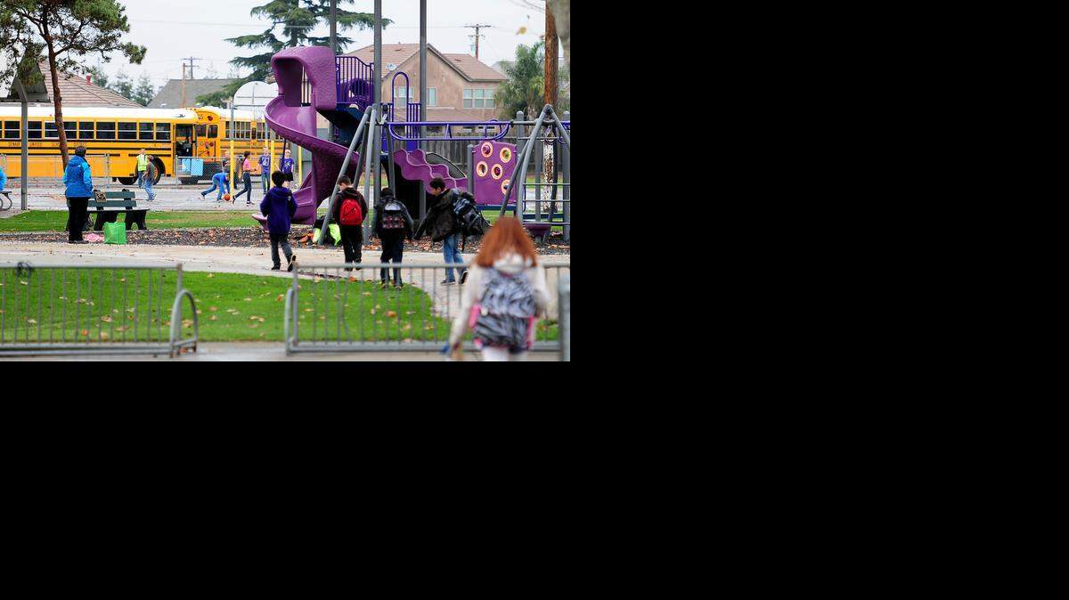 
The school day ends as students walk to their bus at Denair Elementary. The school and the Denair Academic Avenues charter would consolidate as a single charter school under a proposal before the Denair Unified School Board on Thursday.
