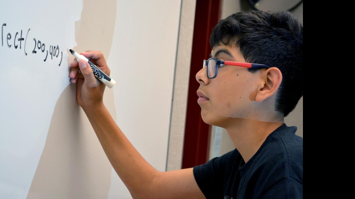 
Eighth-grader David Madrigal writes the code for a rectangle – the first two numbers are the x and y axis coordinates – during a summer computer science session at Hanshaw Middle School in south Modesto last week.
