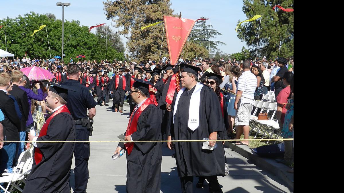 
Members of the Class of 2015 walk to their seats Thursday morning at the commencement ceremony for the College of Business Administration and the College of Science at California State University, Stanislaus. 
