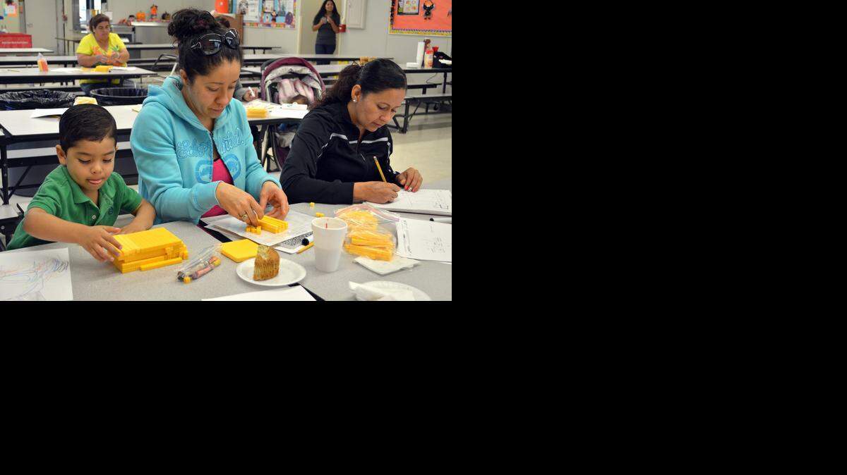 
Julian Mojica, 3, plays with counting blocks in strips of 10 while mom Karina Chavez and Silvia Magana, right, work through a lesson using the blocks to teach borrowing in subtraction at a Muffins & Math session at Robertson Road Elementary in south Modesto on Oct. 24.
