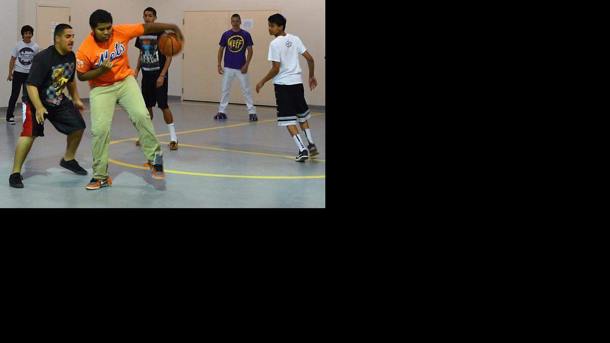 
David Smith, 16, dribbles away from Benil Khodiadeh, 15, during a pickup game of basketball at Fusion Charter school in Turlock last week.
