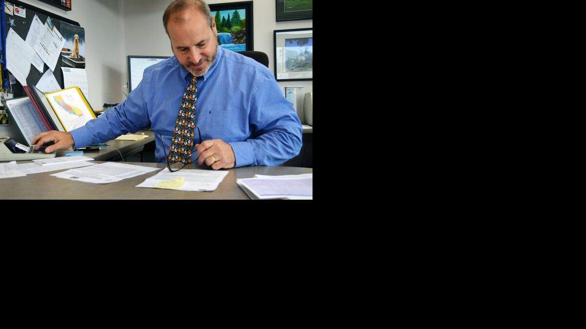 
Deputy Superintendent Don Gatti, who runs the business side of the Stanislaus County Office of Education, checks figures in a memo in his Modesto office last month.
