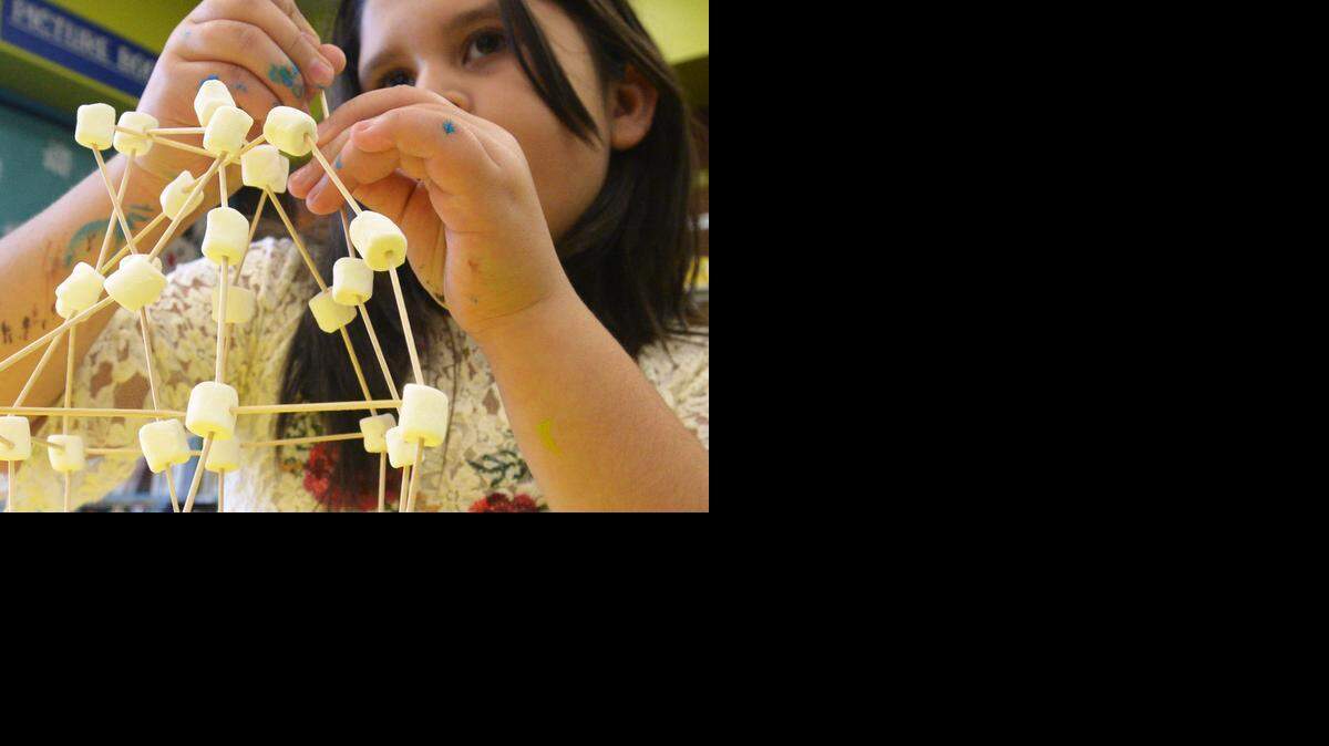 
Genesis Rose, 8, works on her toothpick tower Monday, the first day of Science Week at the Stanislaus County Library in Modesto, Jan. 5, 2015.
