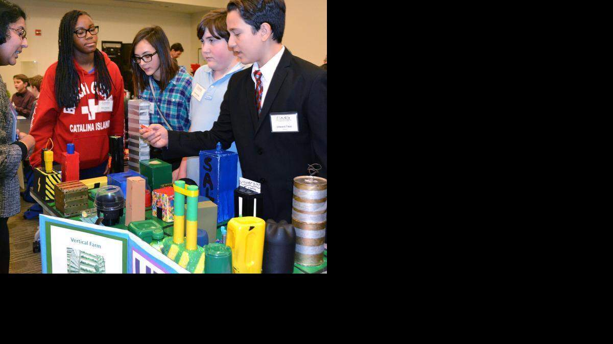 
From left, event judge Viji Gururajan listens to Turlock Junior High students, Starr Charles, Sophia Anderson, Joey Perrello and Edward Yaco explain features of their “city of Utopia” during the Northern California Future City engineering competition at California State University, Stanislaus, in Turlock on Saturday.
