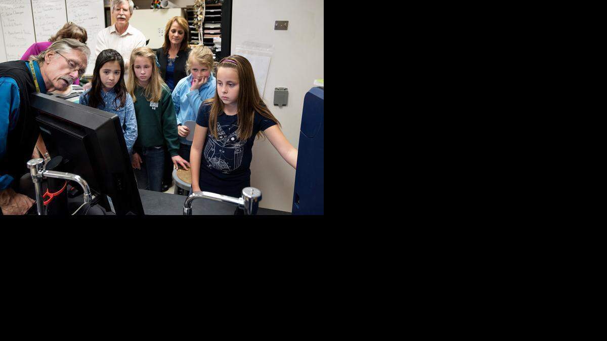 
Enochs science teacher Dave Menshew, left, helps visiting fifth-graders from Sonoma Elementary School examine a Hitachi Corp. scanning electron microscope in Modesto on Wednesday. The students from left: Riley Nunes, 11, Nicole Teeples, 10, Jordan Culvahouse, 11, and Grace Young, 11.
